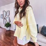 Long sleeved butter yellow ribbed texture pullover with exposed seams throughout and relaxed fit.