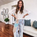 Short sheer beige button down long sleeved top with whimsical embroidery throughout and elastic cuffs.