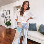 Thin, lightweight wide leg pants with elastic back button and zipper closure, teal, blue and taupe patchwork and mixed fabrics throughout with lace and star patches, pockets and raw hem.