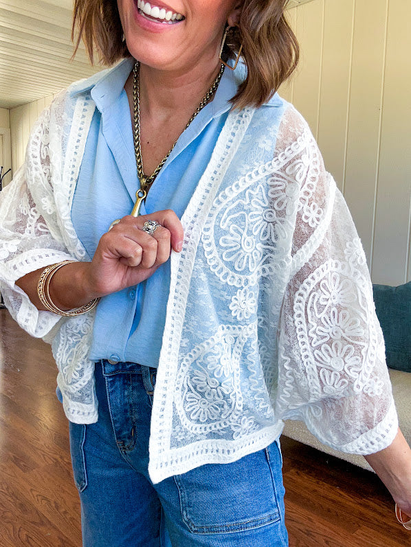 Sheer batwing short cardigan with paisley crochet details throughout.