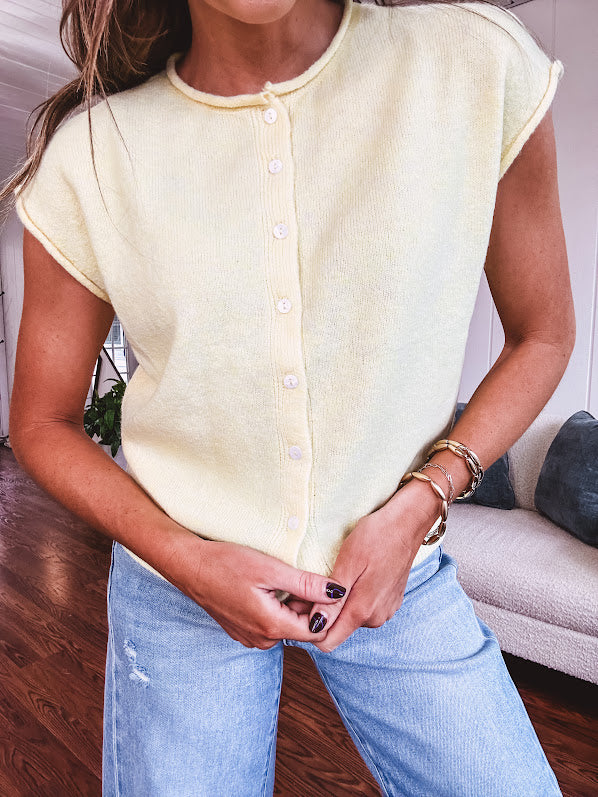 Soft, lightweight and thin cap sleeved button front sweater.