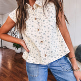 Cream vest with collar and button down front with tiny blue florals throughout.