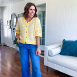 Short sleeved yellow and cream textured weave button down sweater.