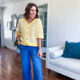 Short sleeved yellow and cream textured weave button down sweater.