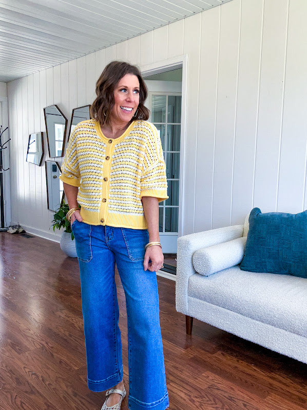 Short sleeved yellow and cream textured weave button down sweater.
