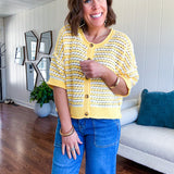 Short sleeved yellow and cream textured weave button down sweater.
