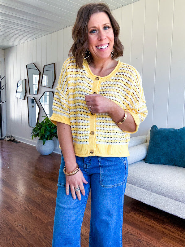 Short sleeved yellow and cream textured weave button down sweater.