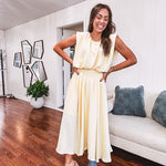 Soft, butter yellow sleeveless top with bubble hem, hook and eye closure at the neck with matching fully lined skirt with flat front waist and pleating with elastic back at the waist, flowy skirt.