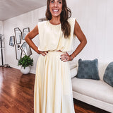Soft, butter yellow sleeveless top with bubble hem, hook and eye closure at the neck with matching fully lined skirt with flat front waist and pleating with elastic back at the waist, flowy skirt.