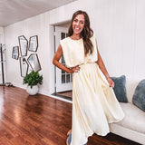 Soft, butter yellow sleeveless top with bubble hem, hook and eye closure at the neck with matching fully lined skirt with flat front waist and pleating with elastic back at the waist, flowy skirt.
