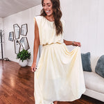 Soft, butter yellow sleeveless top with bubble hem, hook and eye closure at the neck with matching fully lined skirt with flat front waist and pleating with elastic back at the waist, flowy skirt.