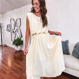 Soft, butter yellow sleeveless top with bubble hem, hook and eye closure at the neck with matching fully lined skirt with flat front waist and pleating with elastic back at the waist, flowy skirt.