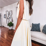Soft, butter yellow sleeveless top with bubble hem, hook and eye closure at the neck with matching fully lined skirt with flat front waist and pleating with elastic back at the waist, flowy skirt.