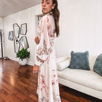 Tan slip dress with long sleeved organza overlay featuring muted florals in pink and cream with vintage inspired design, pearl and gold buttons down the front, cuffs and matching fabric belt with gold accent.