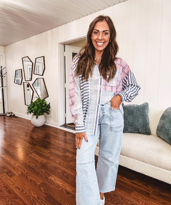 Lightweight, oversized long sleeved button down with pink plaid, light blue plaid and dark blue and white stripes mixed throughout.
