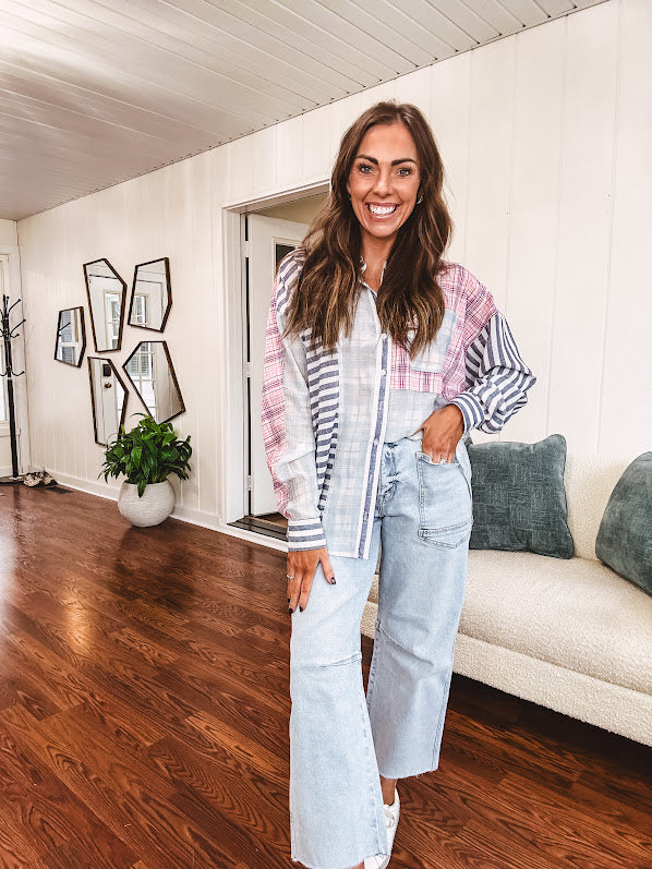 Lightweight, oversized long sleeved button down with pink plaid, light blue plaid and dark blue and white stripes mixed throughout.