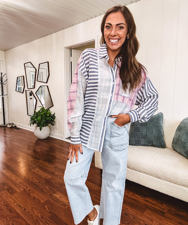 Lightweight, oversized long sleeved button down with pink plaid, light blue plaid and dark blue and white stripes mixed throughout.
