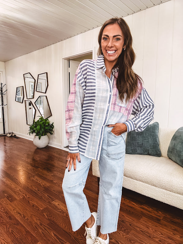 Lightweight, oversized long sleeved button down with pink plaid, light blue plaid and dark blue and white stripes mixed throughout.