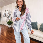 Lightweight, oversized long sleeved button down with pink plaid, light blue plaid and dark blue and white stripes mixed throughout.