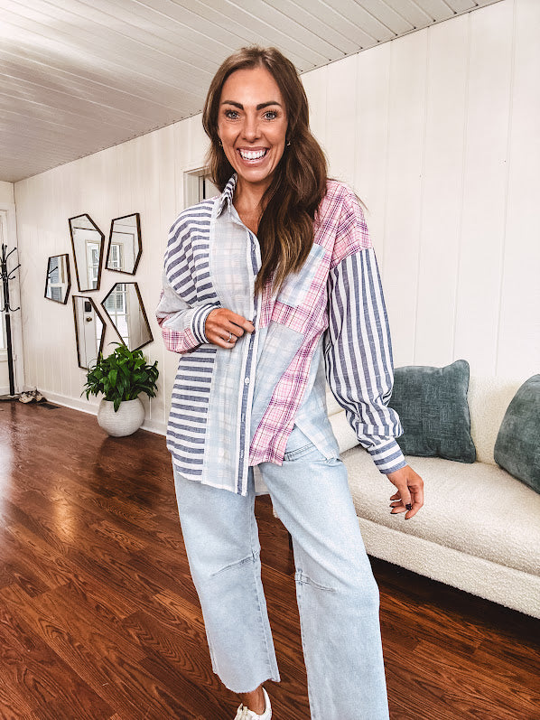 Lightweight, oversized long sleeved button down with pink plaid, light blue plaid and dark blue and white stripes mixed throughout.