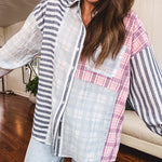 Lightweight, oversized long sleeved button down with pink plaid, light blue plaid and dark blue and white stripes mixed throughout.