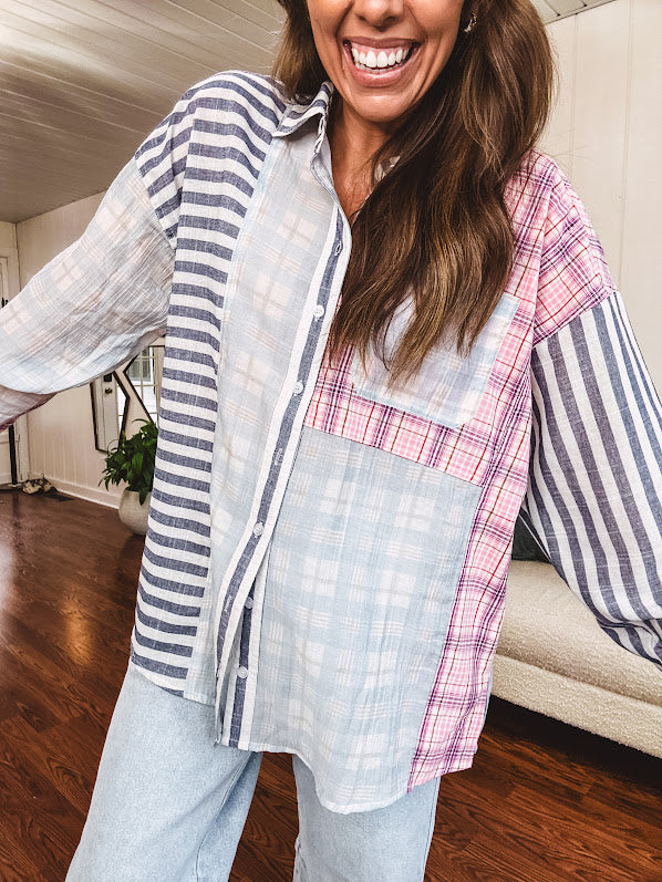 Lightweight, oversized long sleeved button down with pink plaid, light blue plaid and dark blue and white stripes mixed throughout.