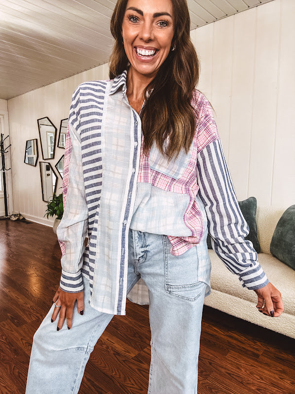 Lightweight, oversized long sleeved button down with pink plaid, light blue plaid and dark blue and white stripes mixed throughout.