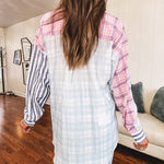 Lightweight, oversized long sleeved button down with pink plaid, light blue plaid and dark blue and white stripes mixed throughout.