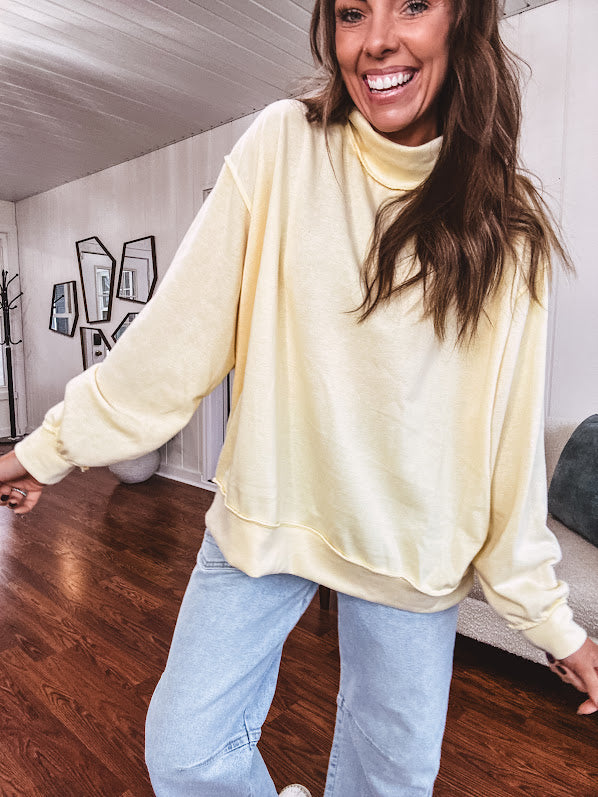 Thin, lightweight soft long sleeved pullover with mock neck and exposed seams, oversized.
