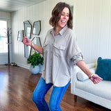 Lightweight Tencel button down top in taupe with adjustable sleeves and front pockets.
