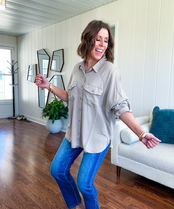 Lightweight Tencel button down top in taupe with adjustable sleeves and front pockets.