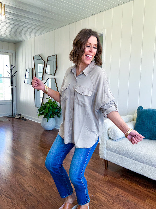 Lightweight Tencel button down top in taupe with adjustable sleeves and front pockets.