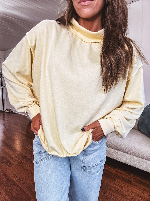 Thin, lightweight soft long sleeved pullover with mock neck and exposed seams, oversized.