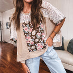 Lightweight ribbed textured taupe top with lace at the yoke and sides and a brown and pink and blue floral patch in the front at at the cuffs of the short sleeves. Oversized.