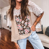 Lightweight ribbed textured taupe top with lace at the yoke and sides and a brown and pink and blue floral patch in the front at at the cuffs of the short sleeves. Oversized.