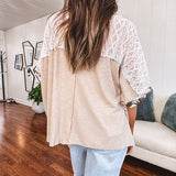 Lightweight ribbed textured taupe top with lace at the yoke and sides and a brown and pink and blue floral patch in the front at at the cuffs of the short sleeves. Oversized.