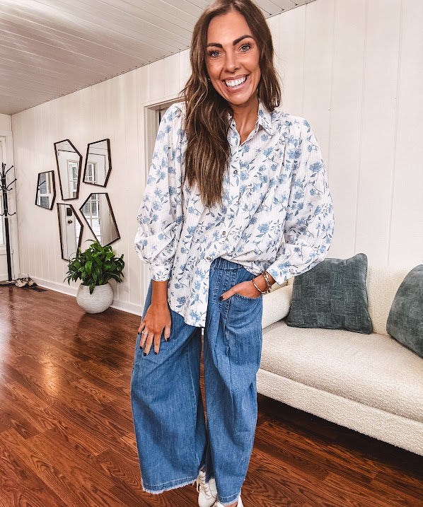 Long sleeved white button down with window pane pattern and blue watercolor florals throughout.