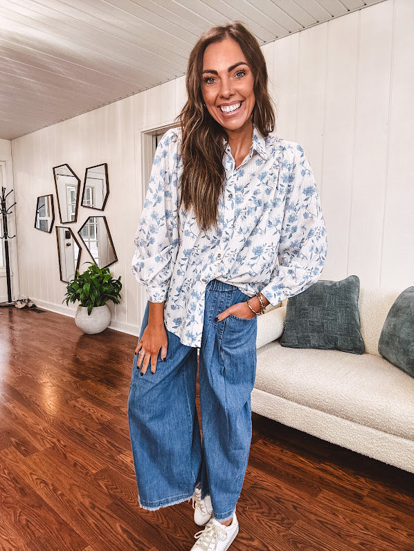 Long sleeved white button down with window pane pattern and blue watercolor florals throughout.