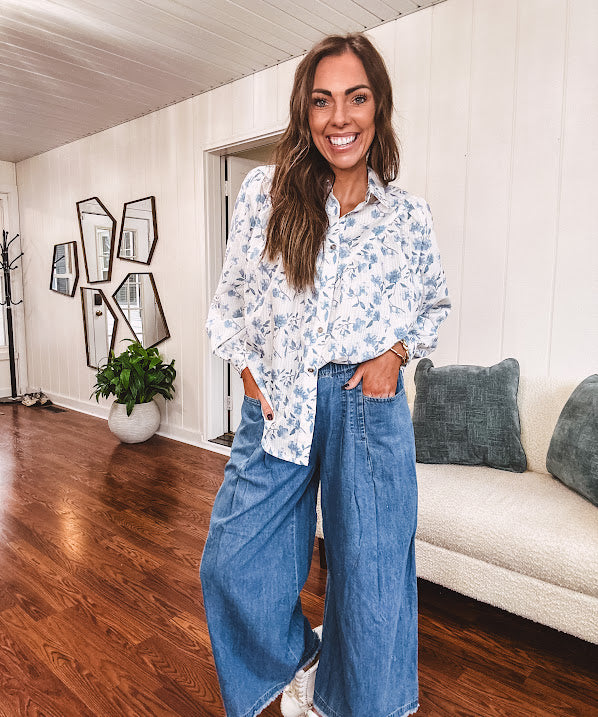Long sleeved white button down with window pane pattern and blue watercolor florals throughout.