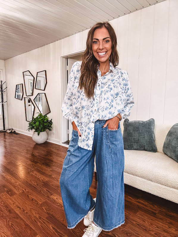 Long sleeved white button down with window pane pattern and blue watercolor florals throughout.