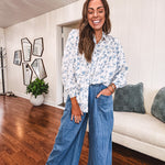 Medium wash chambray wide leg pants with pintuck detail, elastic waist and raw hems.