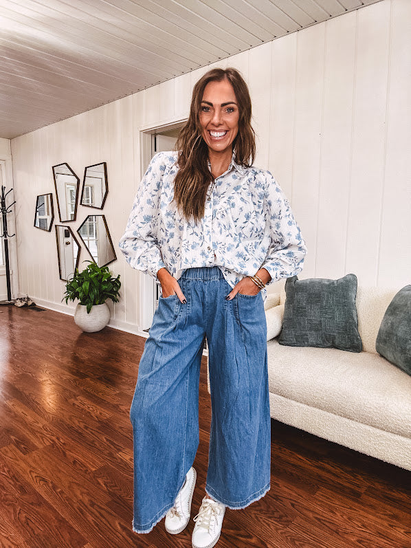 Long sleeved white button down with window pane pattern and blue watercolor florals throughout.