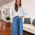 Medium wash chambray wide leg pants with pintuck detail, elastic waist and raw hems.