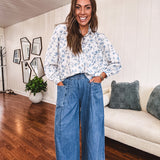 Medium wash chambray wide leg pants with pintuck detail, elastic waist and raw hems.