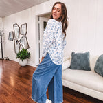 Medium wash chambray wide leg pants with pintuck detail, elastic waist and raw hems.