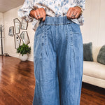Medium wash chambray wide leg pants with pintuck detail, elastic waist and raw hems.