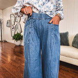Medium wash chambray wide leg pants with pintuck detail, elastic waist and raw hems.