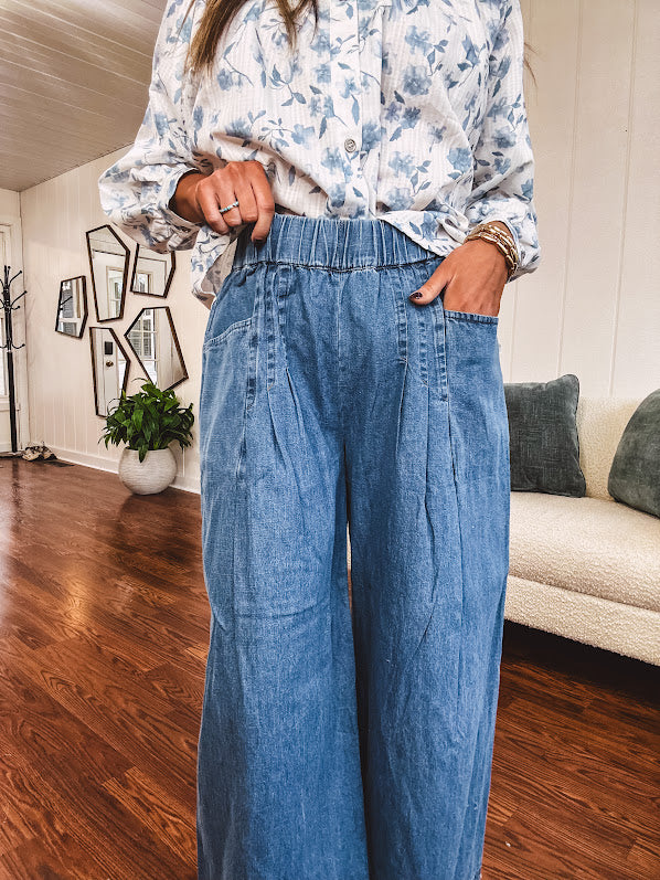 Medium wash chambray wide leg pants with pintuck detail, elastic waist and raw hems.