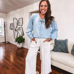 Thin, light denim flowy top with long sleeves and tie front at the neck.