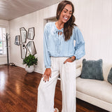 Thin, light denim flowy top with long sleeves and tie front at the neck.